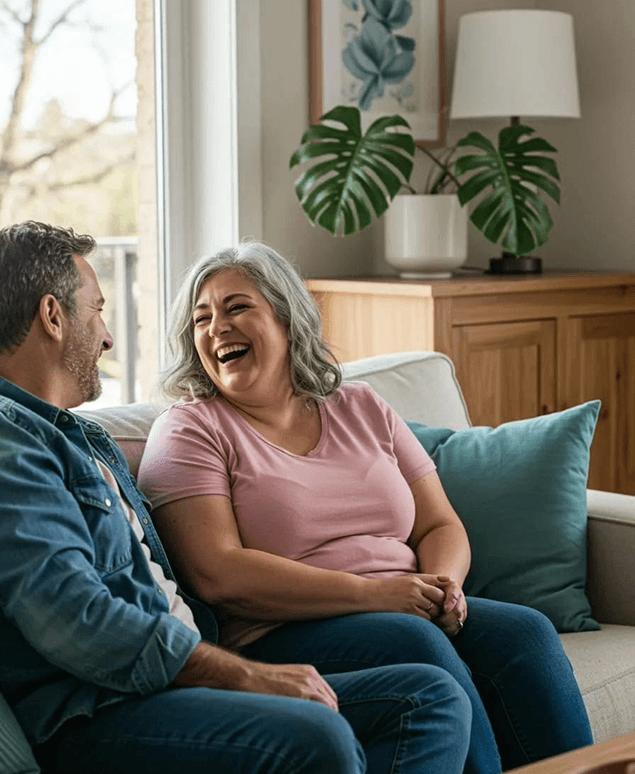 Couple laughing on sofa